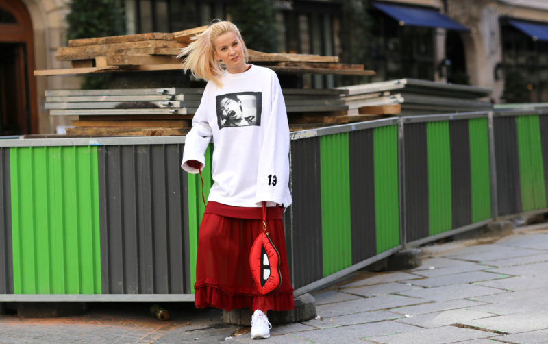 weißer oversized pullover mit motiv, rotes maxikleid, statement handtasche