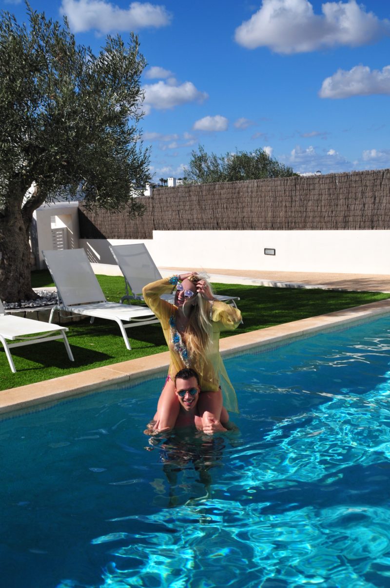 couple, pool, sun, yellow top, sunglasses