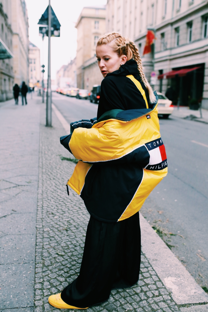 black and yellow, oversized winter jacket, black pants, yellow sneakers