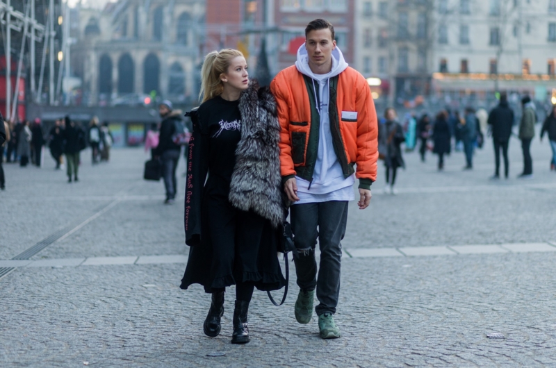 PARIS, FRANCE - JANUARY 24: Palina Pralina wearing fur coat, Vetements dress, Vetements shoes, 3.1. Phillip Lim bag and Maximilian Schiefer wearing orange bomber jacket, white hoody outside Vetements on January 24, 2017 in Paris, Canada. (Photo by Christian Vierig/Getty Images) *** Local Caption ***