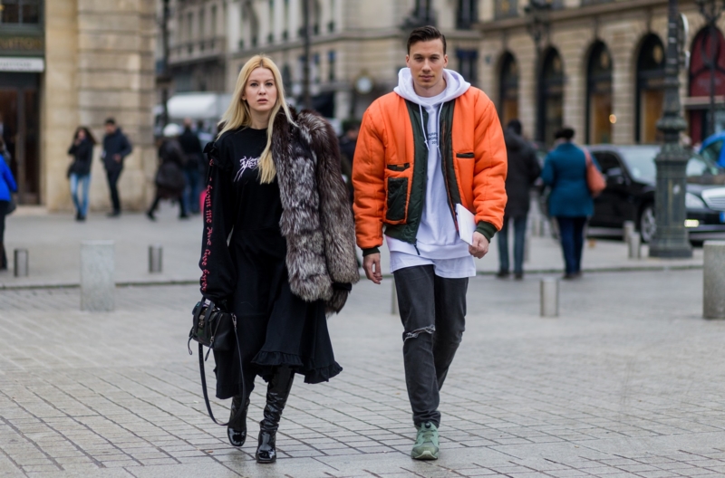 PARIS, FRANCE - JANUARY 24: Palina Pralina wearing fur coat, Vetements dress, Asos shoes, 3.1. Phillip Lim bag and Maximilian Schiefer wearing orange bomber jacket, white hoody outside Alexis Mabille on January 24, 2017 in Paris, Canada. (Photo by Christian Vierig/Getty Images) *** Local Caption *** Palina Pralina; Maximilian Schiefer